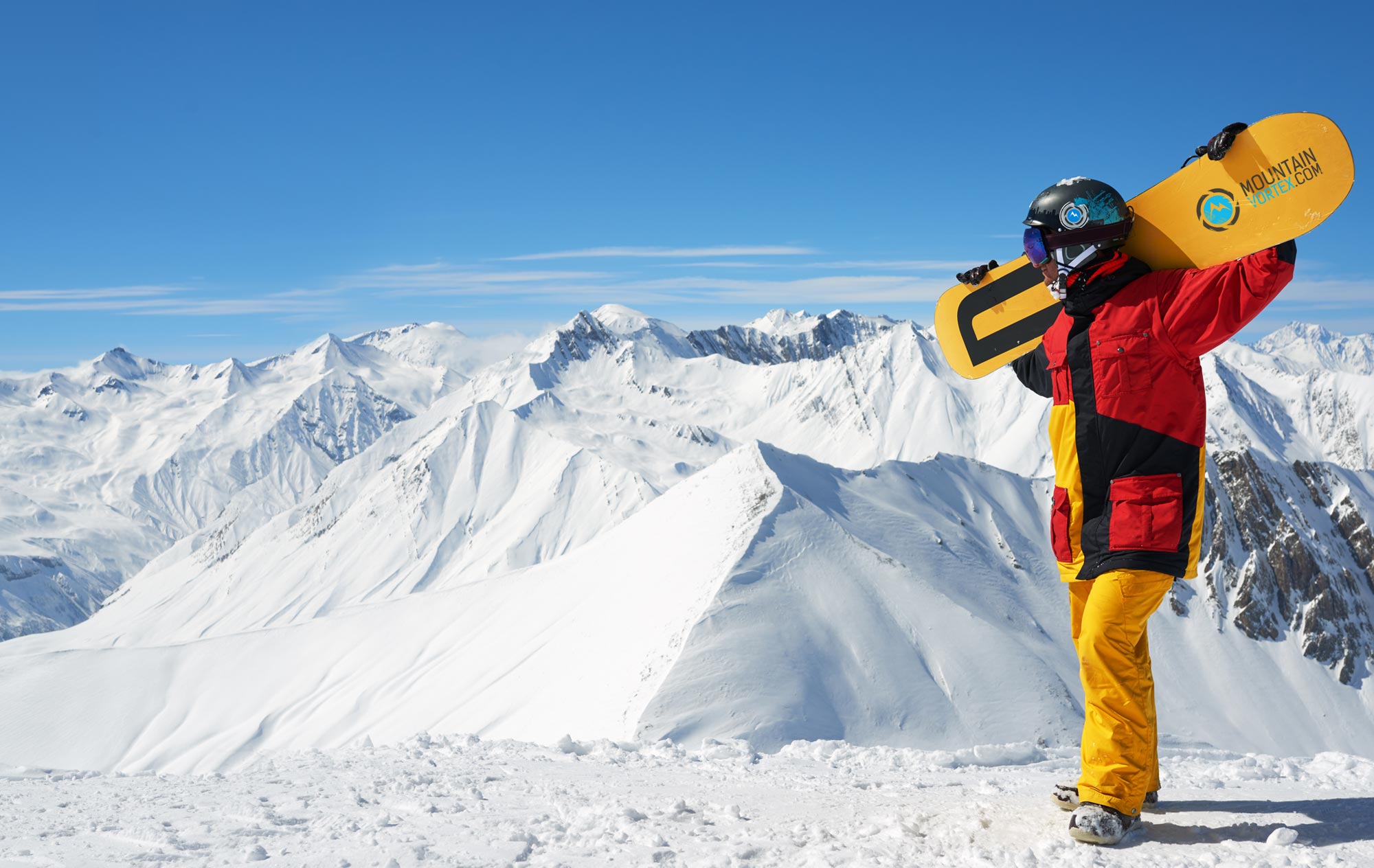 Mountain Vortex snowboarder holds snowboard over his shoulders